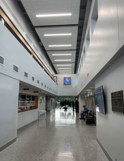Photo of new ceiling in Liberty City Hall with stained glass piece on wall below