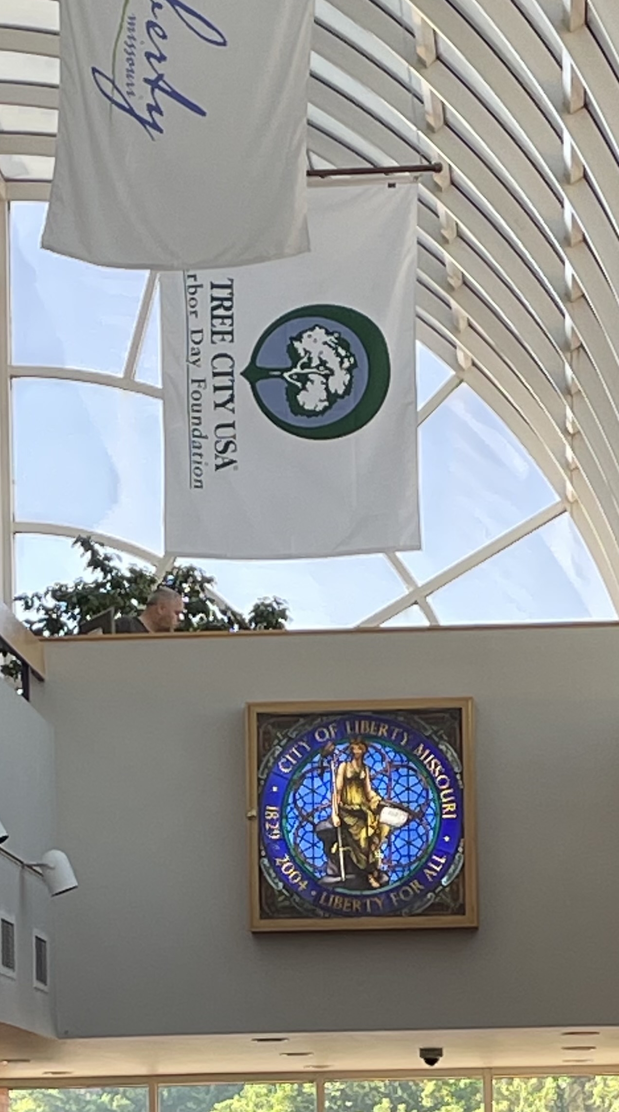 Photo of the City of Liberty flag hanging from the old ceiling in City Hall